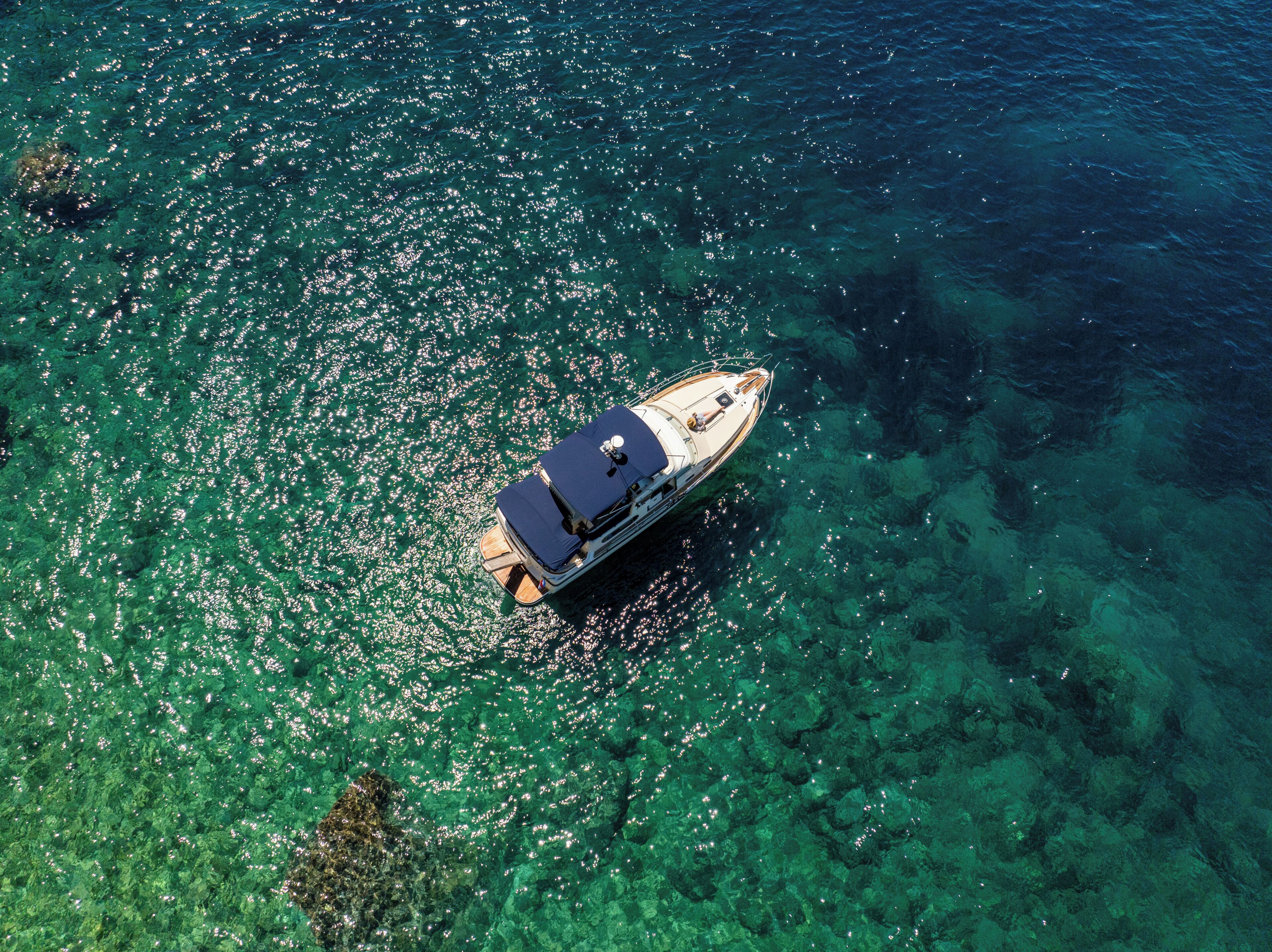 A boat on clear turquoise water.