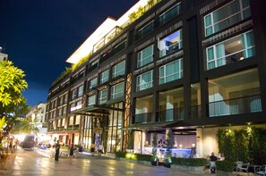 A multi-story hotel with balconies, large windows, and outdoor seating areas. - Aya Boutique Hotel Pattaya (Pattaya)