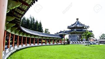 A traditional Chinese pavilion with a curved roof and a central tower.