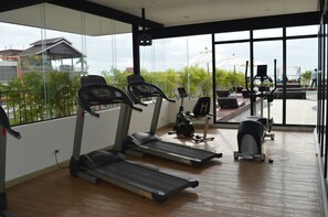 A gym with treadmills, a stationary bike, and weight machines. - Aya Boutique Hotel Pattaya (Pattaya)