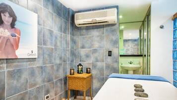 A modern bathroom with a large mirror, a sink, and a towel rack.
