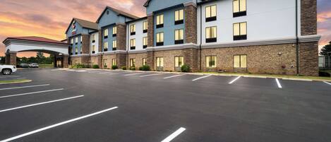 A hotel with a modern design, featuring a two-story structure with a flat roof and a covered entrance.