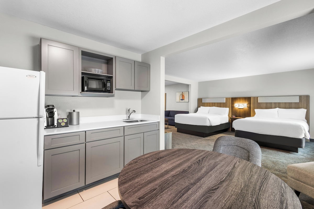 suite, 2 queen beds | 1 bedroom, desk, iron/ironing board, free cots/infant beds