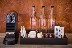 A vintage radio, two glass bottles, a tray with cups and a spoon, and a box with cards and small containers.