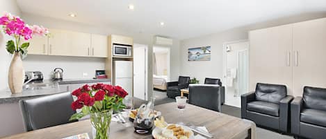 Two Bedroom Deluxe Suite | Living area | 45-inch Smart TV with satellite channels, TV, video-game console