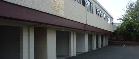 Un bâtiment avec une rangée de places de stationnement vides et une allée couverte.