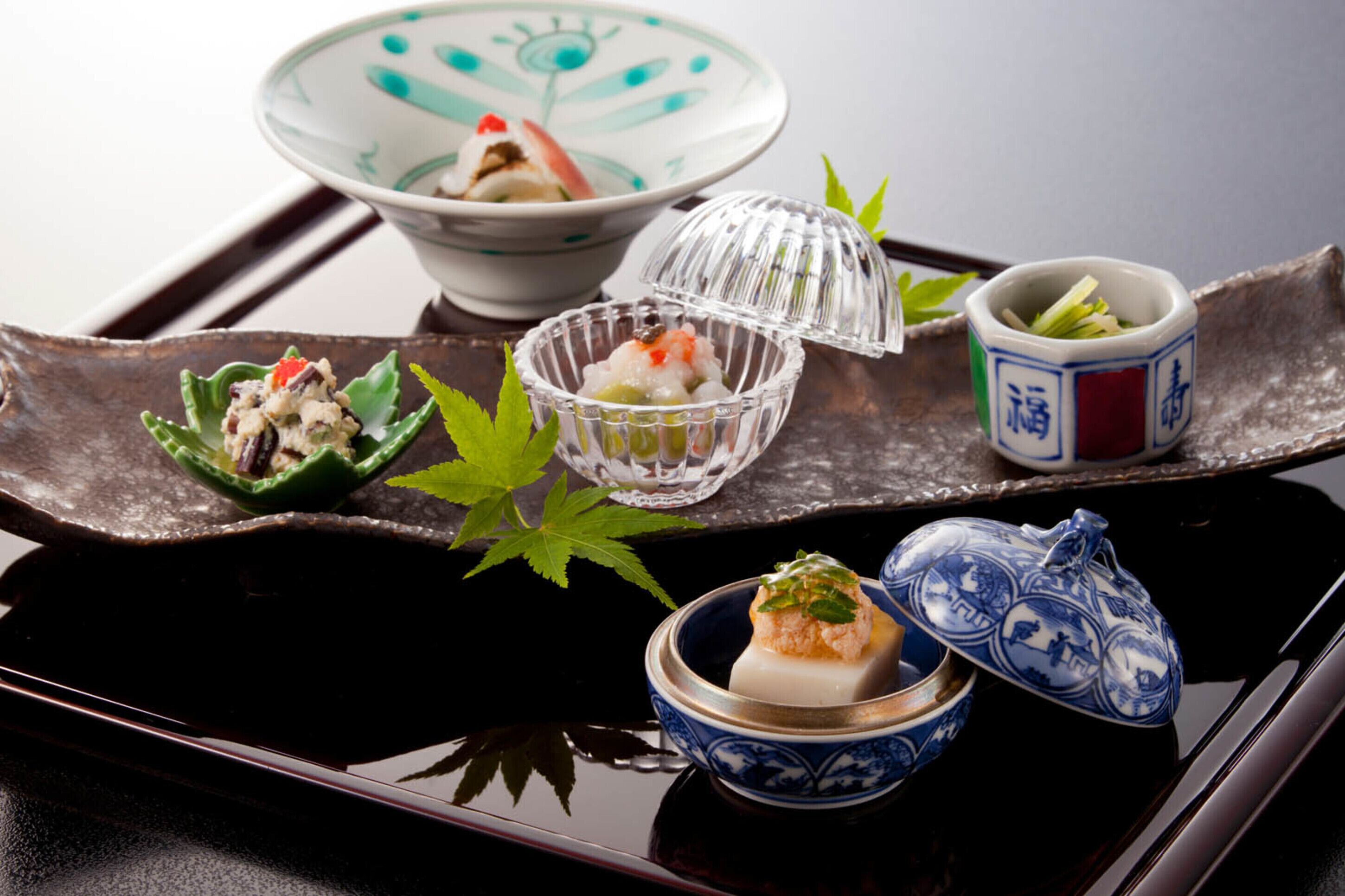 A traditional Japanese meal setup with various dishes on a tray.