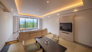 A modern living room with a wooden bench, a dining table, and a flat-screen TV mounted on the wall.