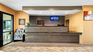 A reception desk with a sign reading "AMERICA'S BEST VALUE INN BY SONESTA". - Americas Best Value Inn Somerville (Somerville)