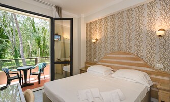 Standard Triple Room | Minibar, in-room safe, desk, iron/ironing board