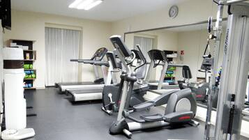A gym with treadmills, elliptical machines, and weight equipment.