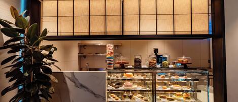 A bakery display with various pastries and desserts.