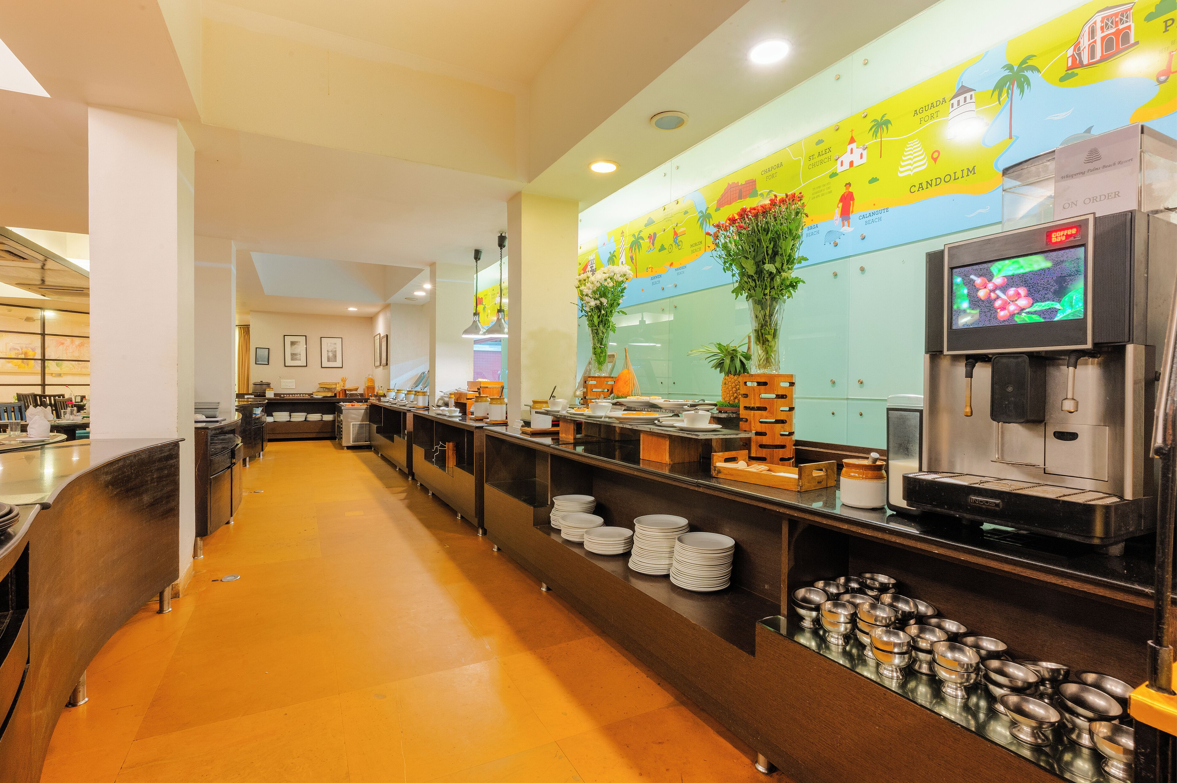 Una larga mesa de buffet con platos y una máquina de café.