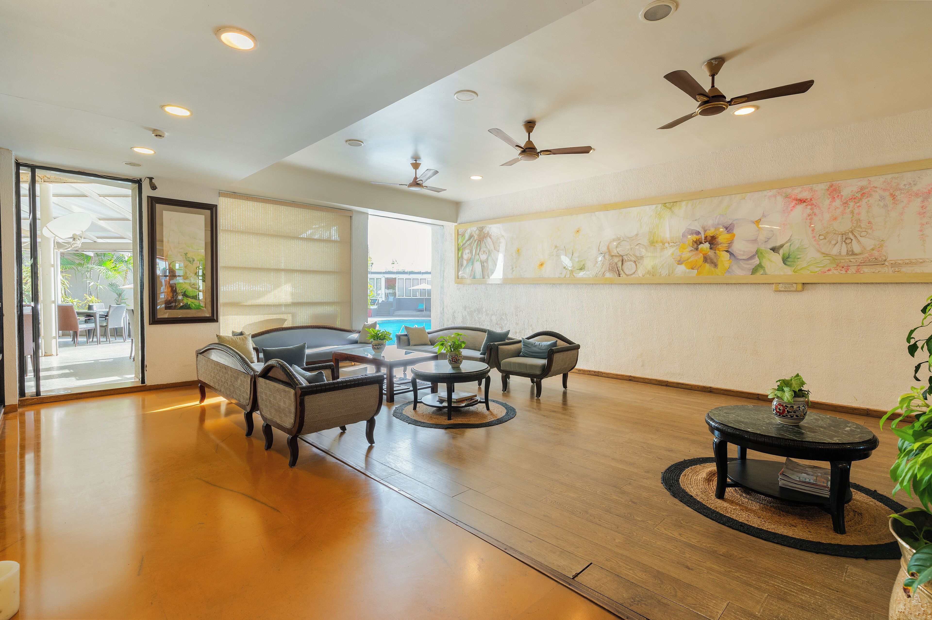 A spacious living area with a sofa set, a coffee table, and a small side table with a plant.