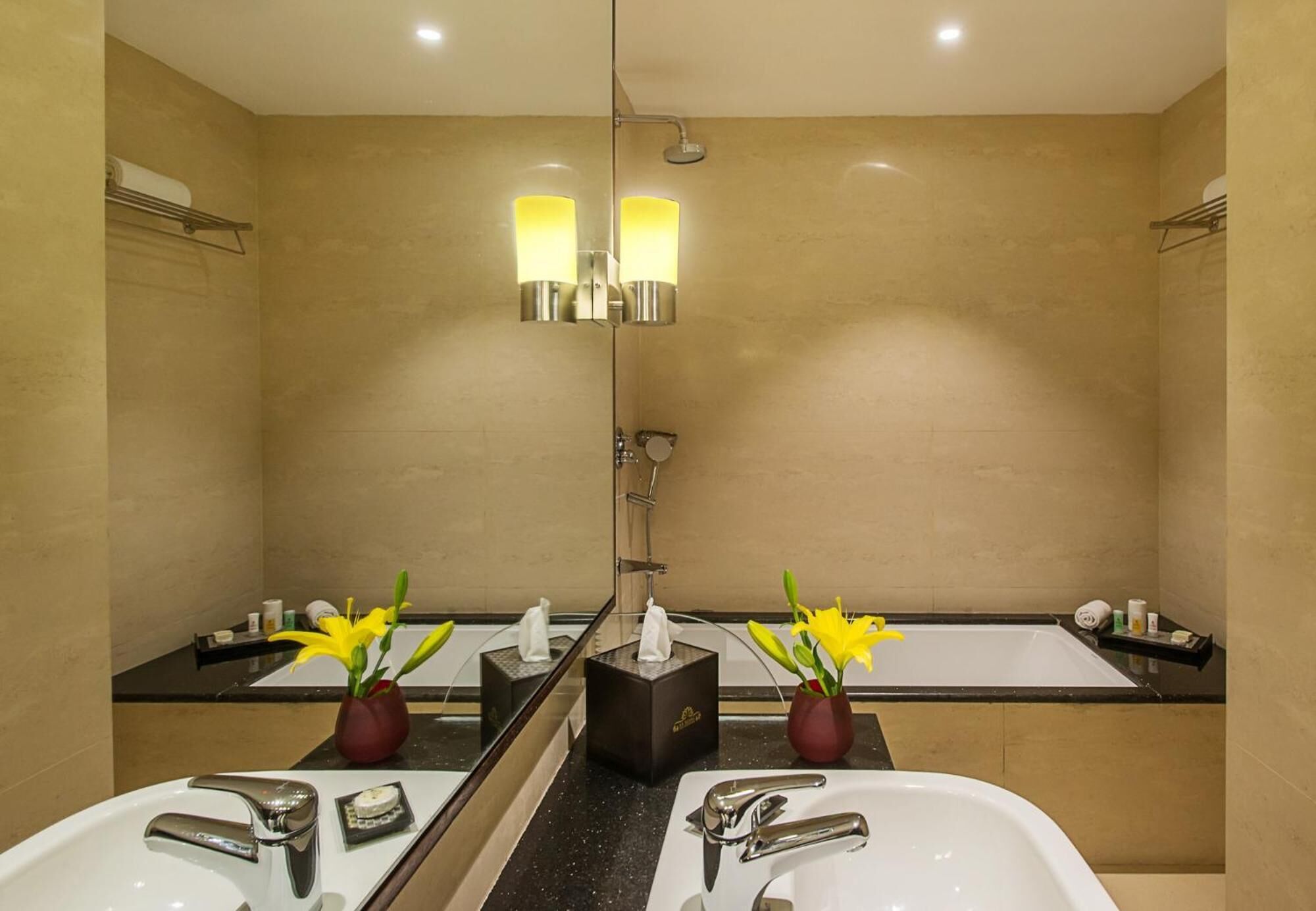 A modern bathroom with two sinks, a shower, and a large mirror.