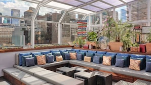 A modern rooftop lounge with a glass ceiling, offering panoramic city views. - Marriott Vacation Club®, New York City (New York)