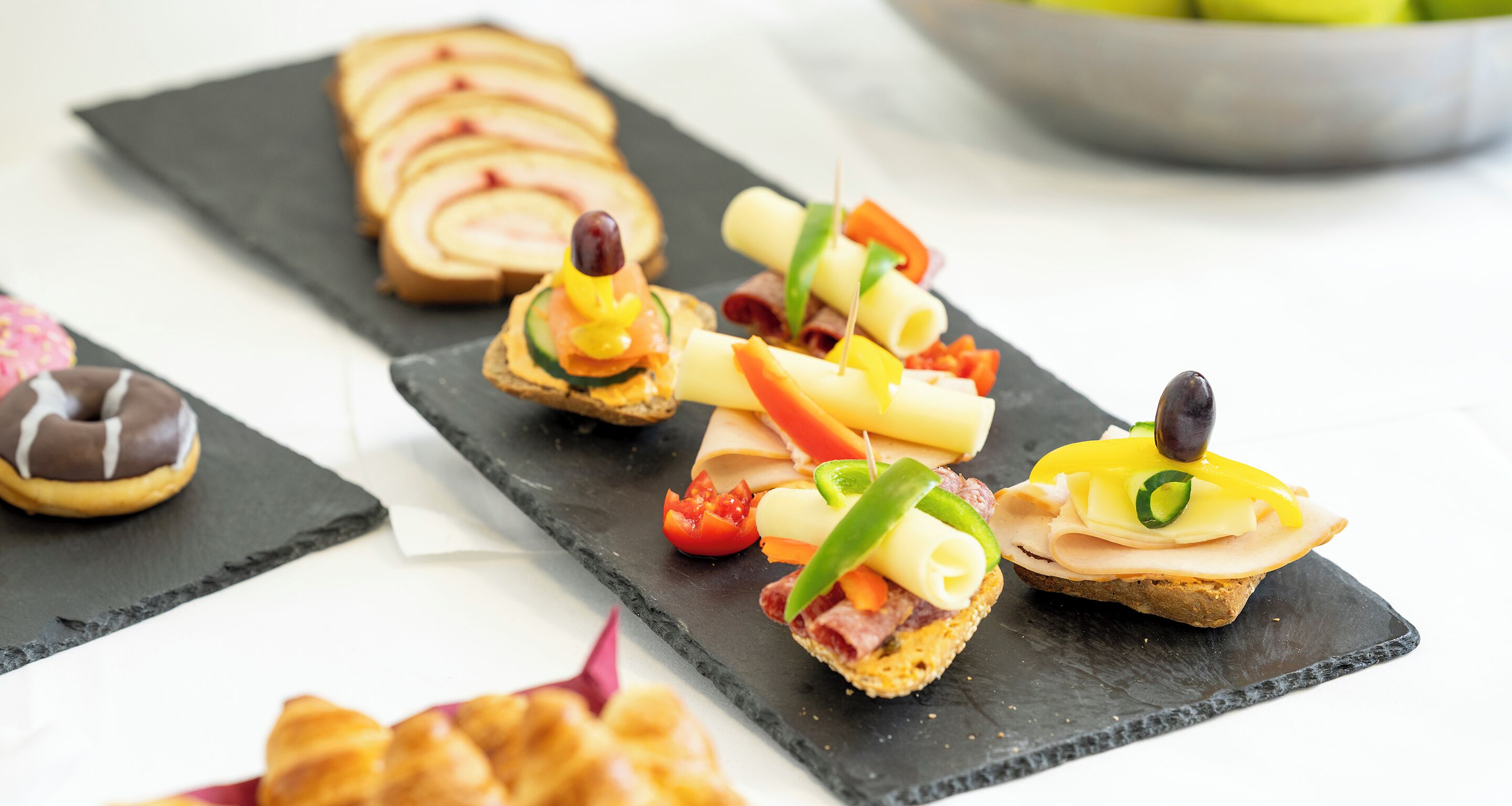 A variety of appetizers on a slate board.