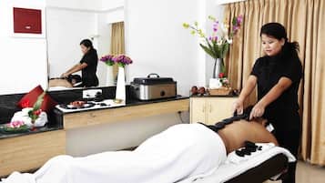 Experience a rejuvenating massage in a serene space with a skilled therapist, a comfortable massage table, and soothing ambiance.