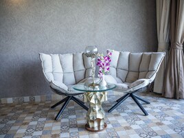 Arabian Sea view Suite on the Beach | Living area | 32-inch flat-screen TV with satellite channels, TV