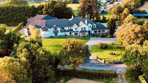 A large, multi-story house with a well-maintained lawn and driveway. - Loch Lein Country House (Killarney)