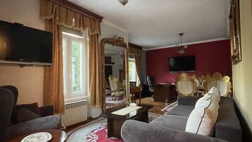 Deluxe Apartment | Living area | 45-cm LCD TV with cable channels, TV