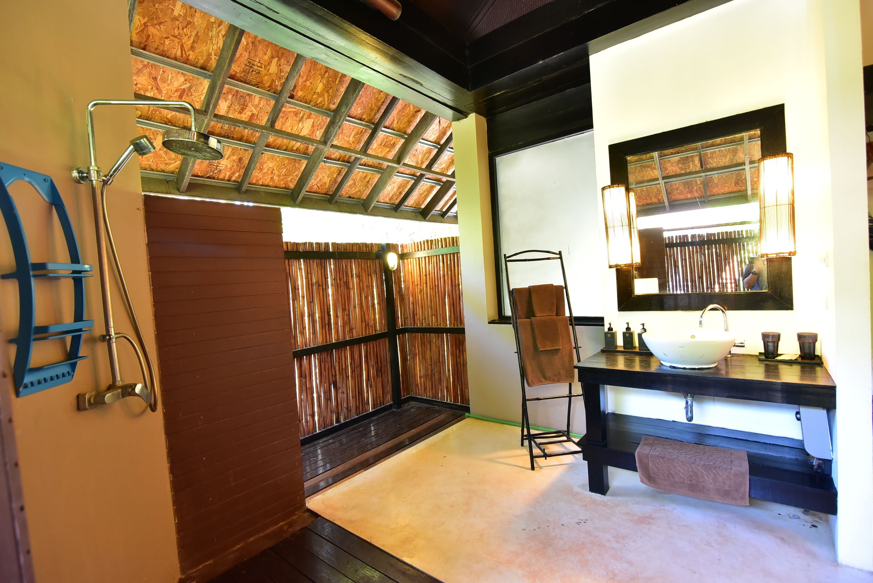 A bathroom with a shower, a sink, and a mirror.