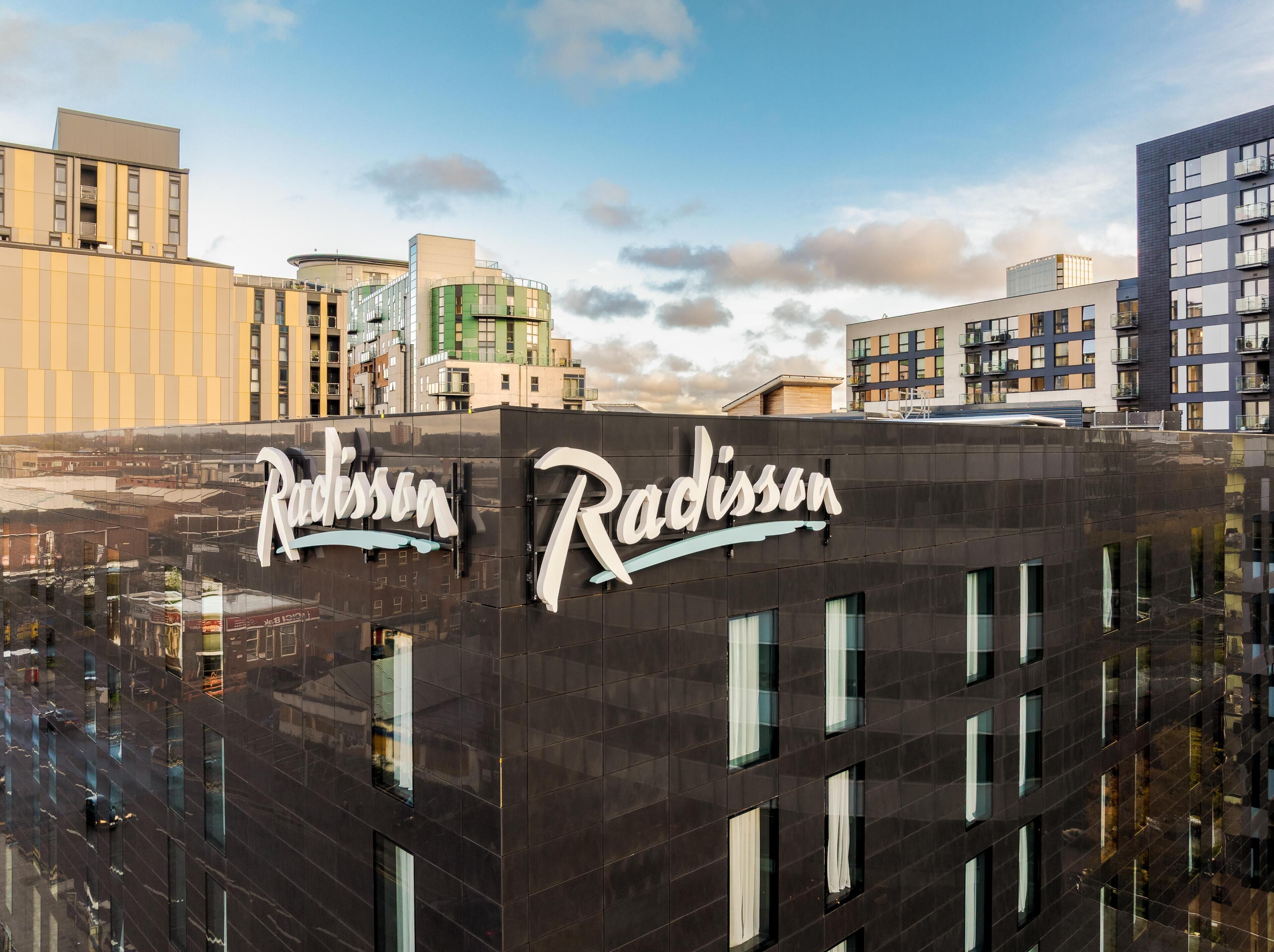 Un edificio moderno con el nombre 'Radisson' destacado en su fachada.