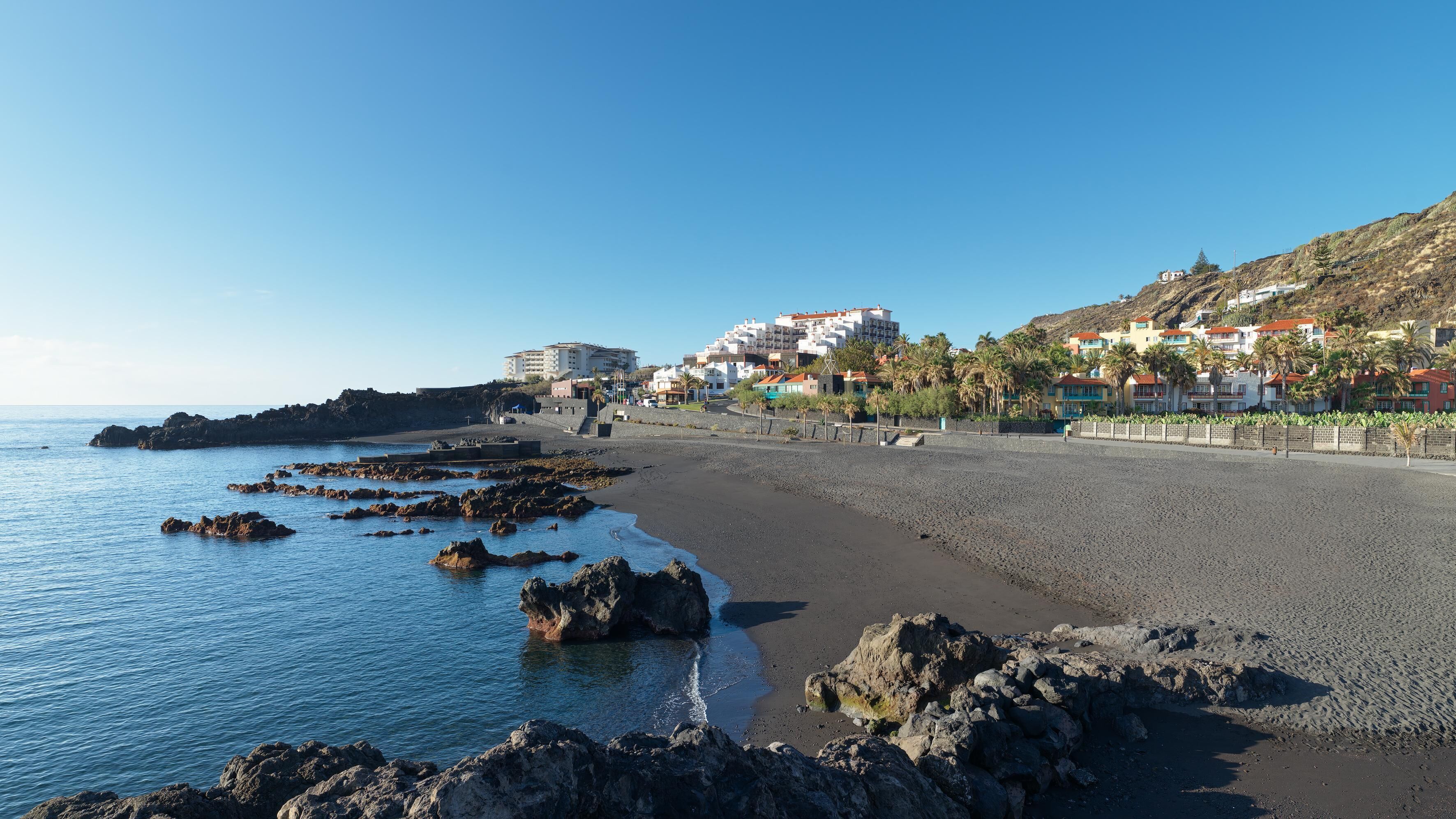 On the beach, black sand