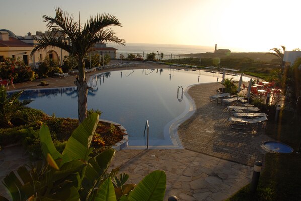 Piscine extérieure, parasols de plage, chaises longues
