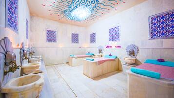 Enjoy a spa-like experience with a bathtub, sinks, and decorative fixtures.