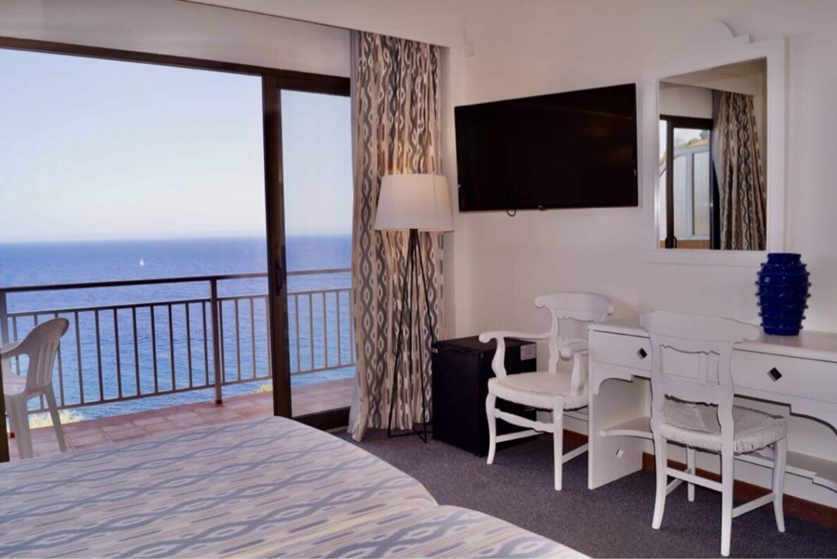 double room, balcony, sea view | in-room safe, desk, laptop workspace, blackout curtains