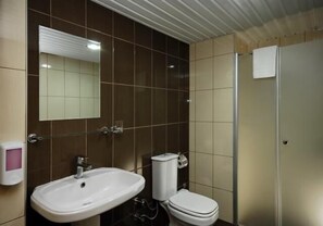 A bathroom with a sink, toilet, and a mirror. - Sealine Hotel (Alanya)