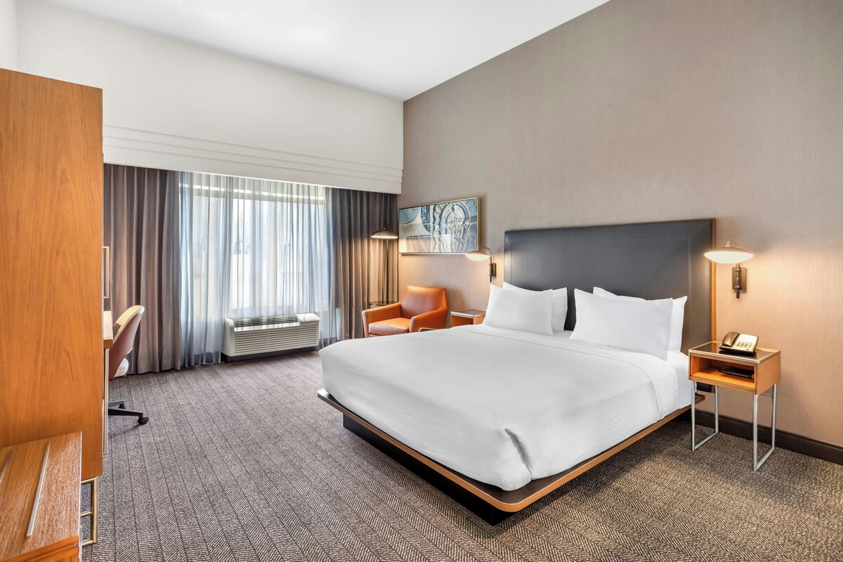 Premium bedding, desk, laptop workspace, blackout drapes