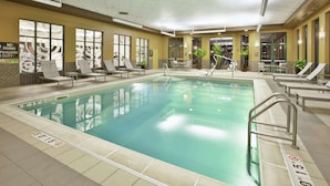 A large indoor swimming pool with clear lane markings, sun loungers, and a no diving sign on the wall. - Embassy Suites Columbus-Airport (Columbus)