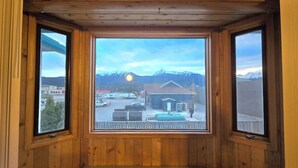 A room with wooden walls and large windows. - Alpine Inn (Valemount)