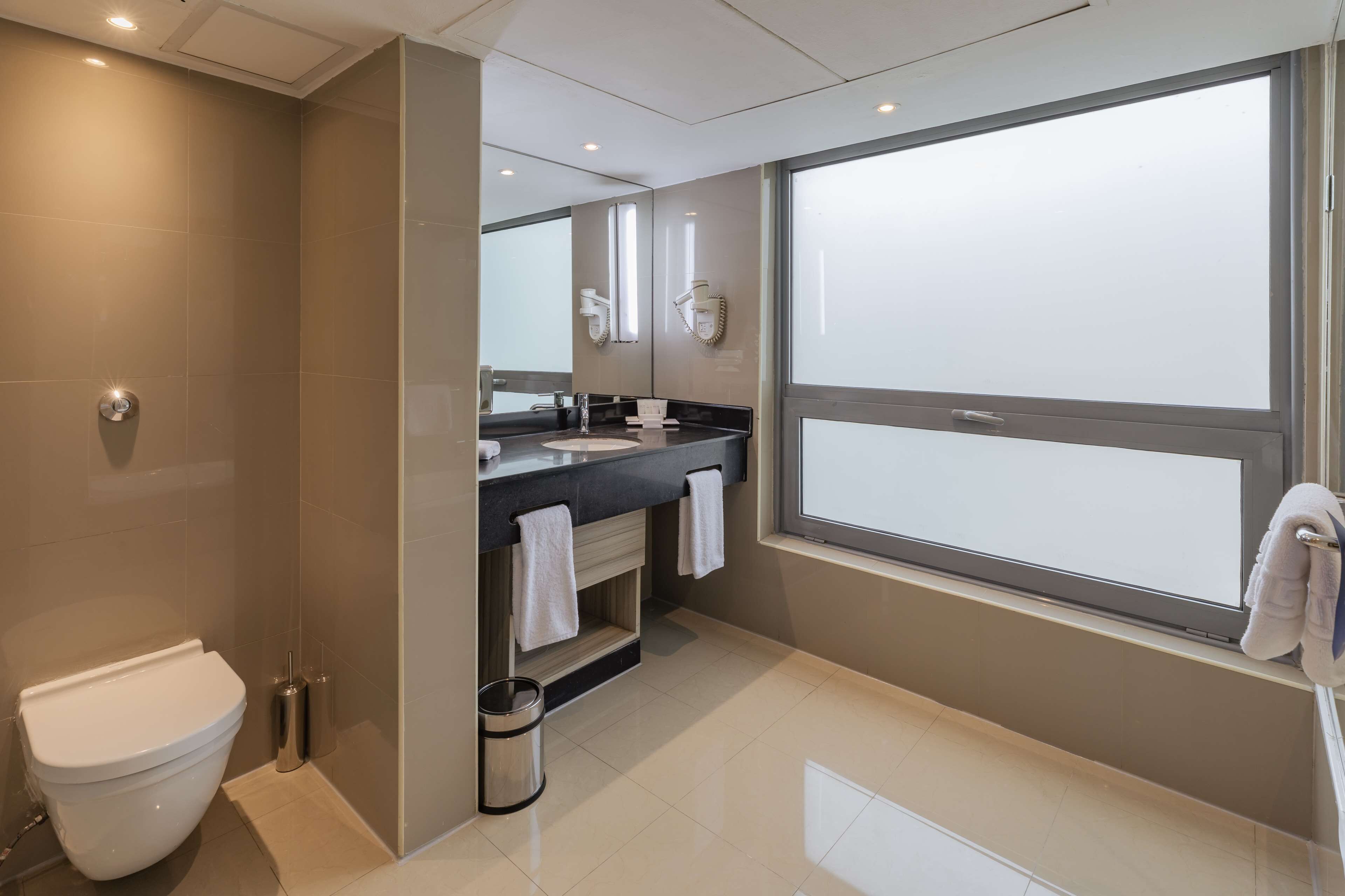 junior suite | bathroom | combined shower/bathtub, designer toiletries, hair dryer, bathrobes