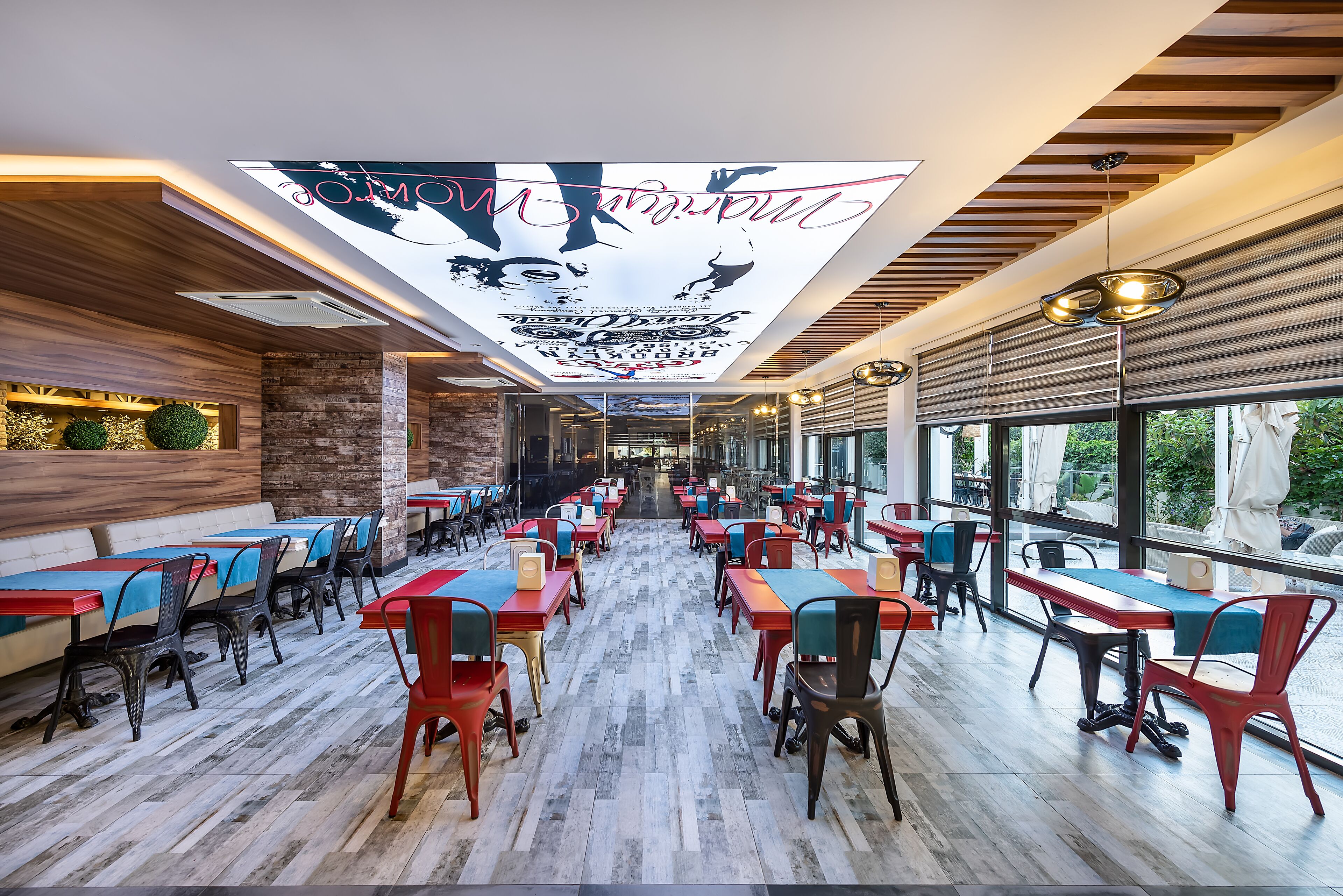 Un restaurante con una barra larga, varias mesas y sillas.