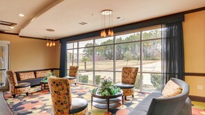 A lobby with a large window, multiple chairs, a sofa, and a patterned carpet. - Comfort Suites Kilgore (Kilgore)