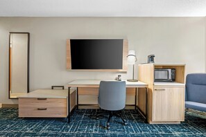 A hotel room with a desk, chair, flat-screen TV, microwave, and a cabinet. - Fairfield Inn & Suites by Marriott Gadsden (Gadsden)