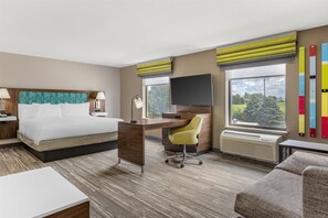 A hotel room with a bed, desk, chair, TV, and large windows. - Hampton Inn & Suites Crawfordsville (Crawfordsville)