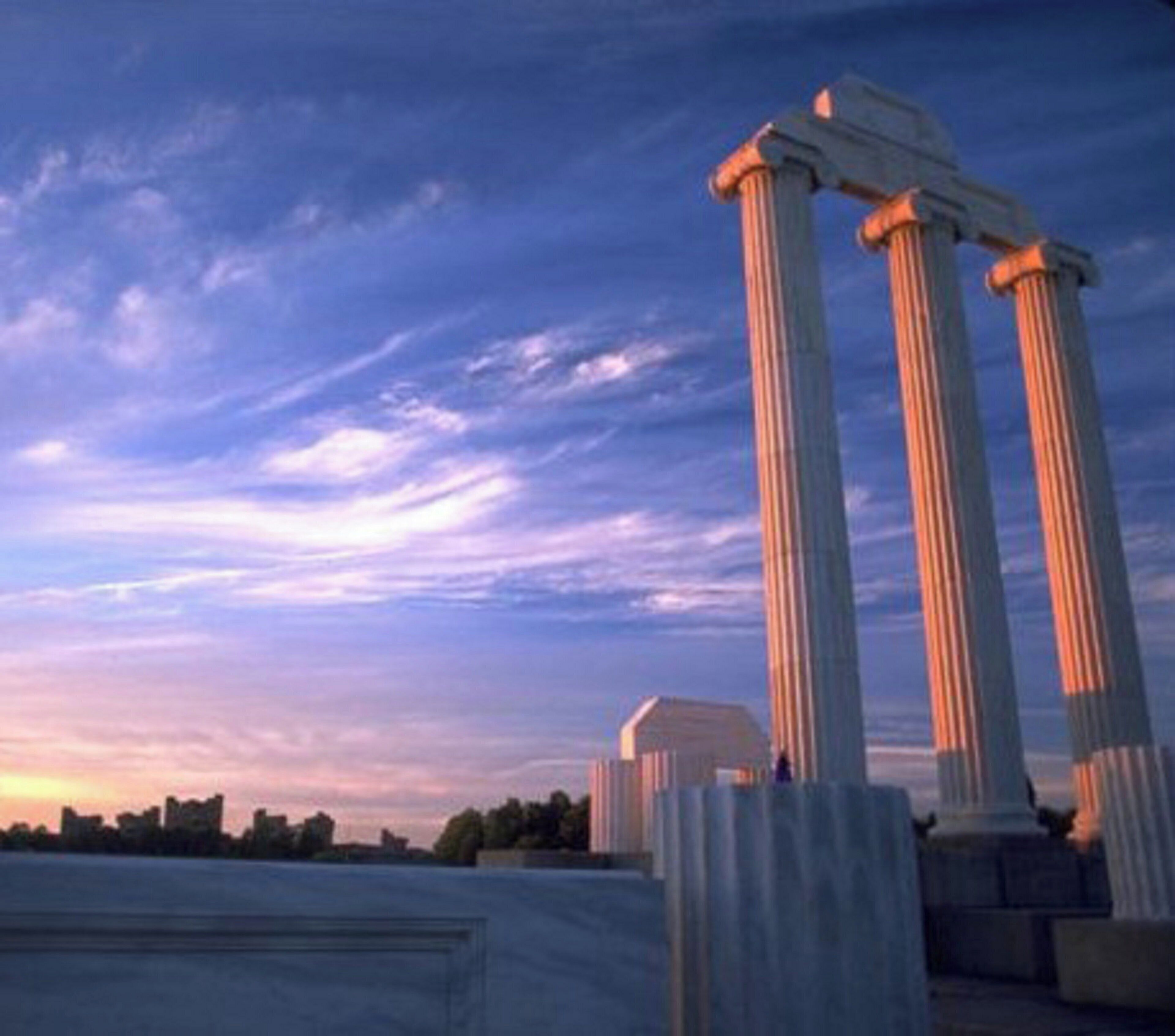 A set of classical columns with a clear sky in the background.