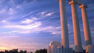 A set of classical columns with a clear sky in the background.