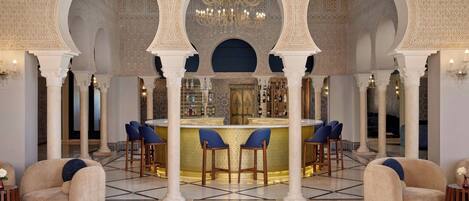 A bar area with a high ceiling, ornate arches, and a chandelier.
