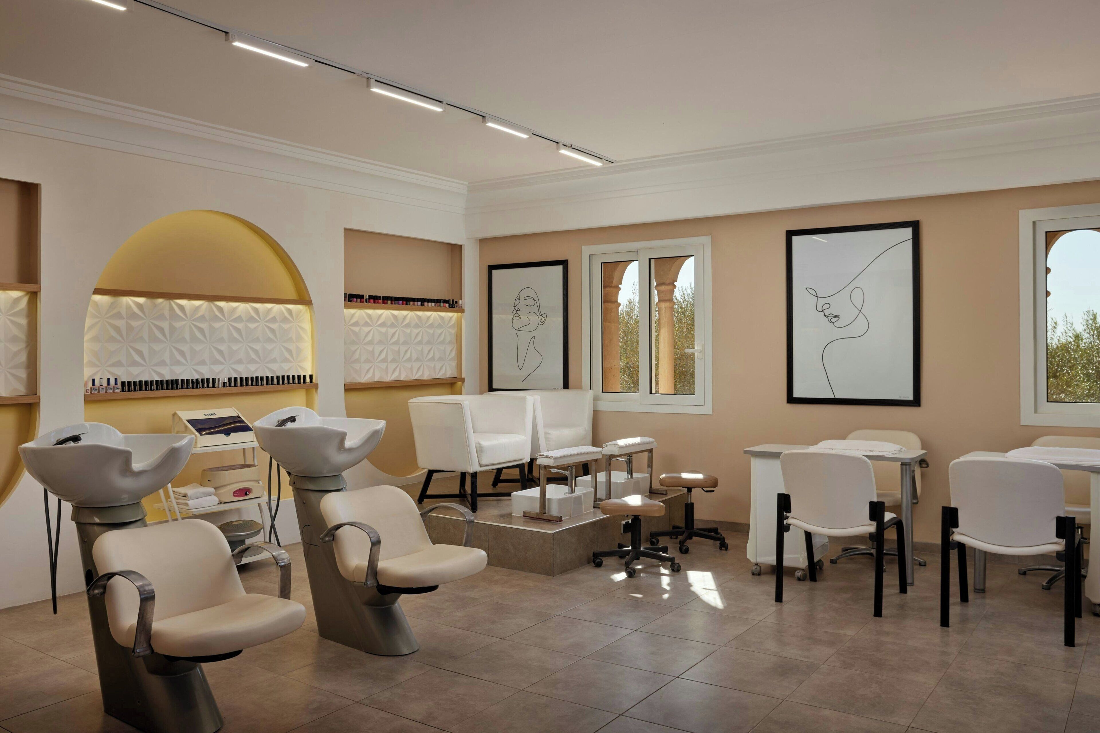 A salon with modern chairs, a reception desk, and framed artwork on the walls.