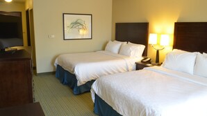 A hotel room with two beds, a television, a framed artwork on the wall, and a bedside lamp. - Holiday Inn Express Waterloo Cedar Falls by IHG (Waterloo)