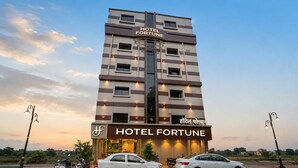 A multi-story hotel building with a sign reading 'HOTEL FORTUNE' and a smaller sign in another language. - Hotel Fortune (Mumbai)