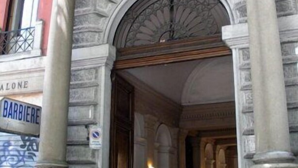 A building entrance with ornate stonework and a sign for 'BARBIERE'. - Fitzroy Allegria Suites (Rome)