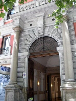 A building entrance with ornate stonework and a sign for 'BARBIERE'. - Fitzroy Allegria Suites (Rome)