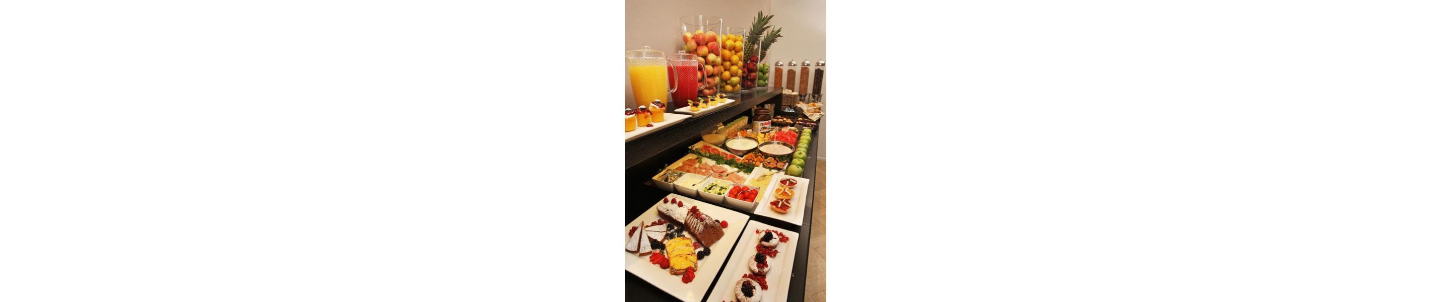 A buffet with various food items and beverages.