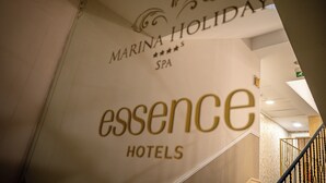 A sign for Marina Holiday Spa and Essence Hotels.